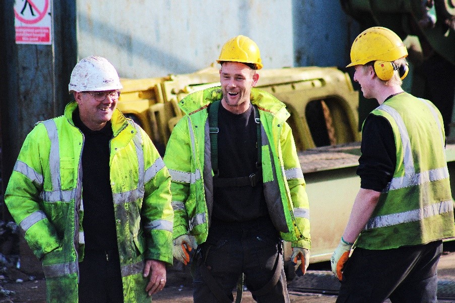 workers in hi-vis laughing