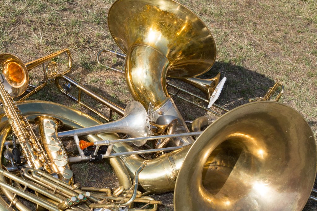 lot of golden and steel musical copper wind instruments