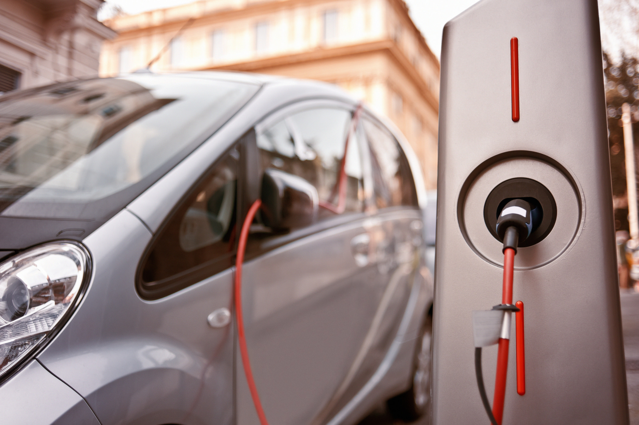 An electric car charging on the street