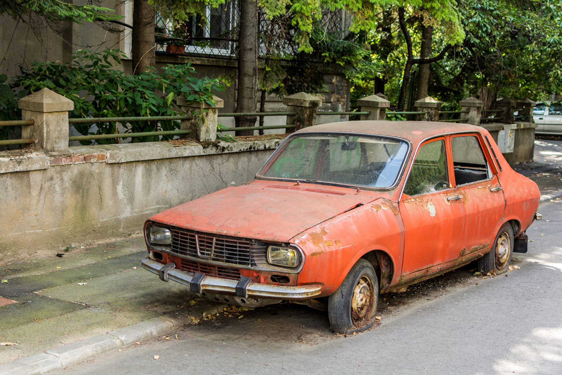 scrap orange car on a road