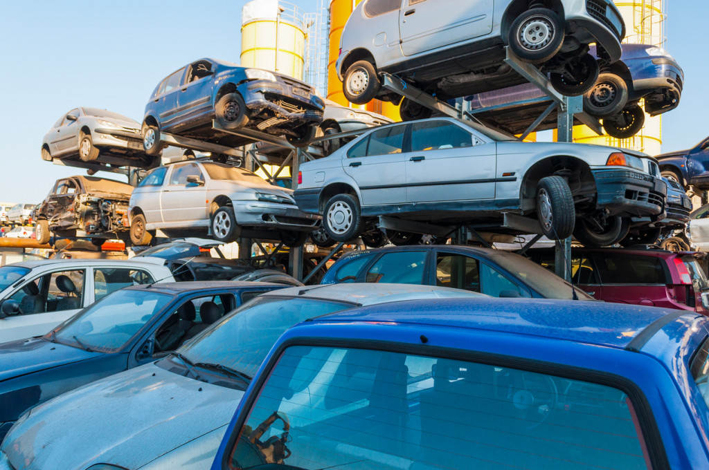 Old cars stacked in a car breaker junkyard