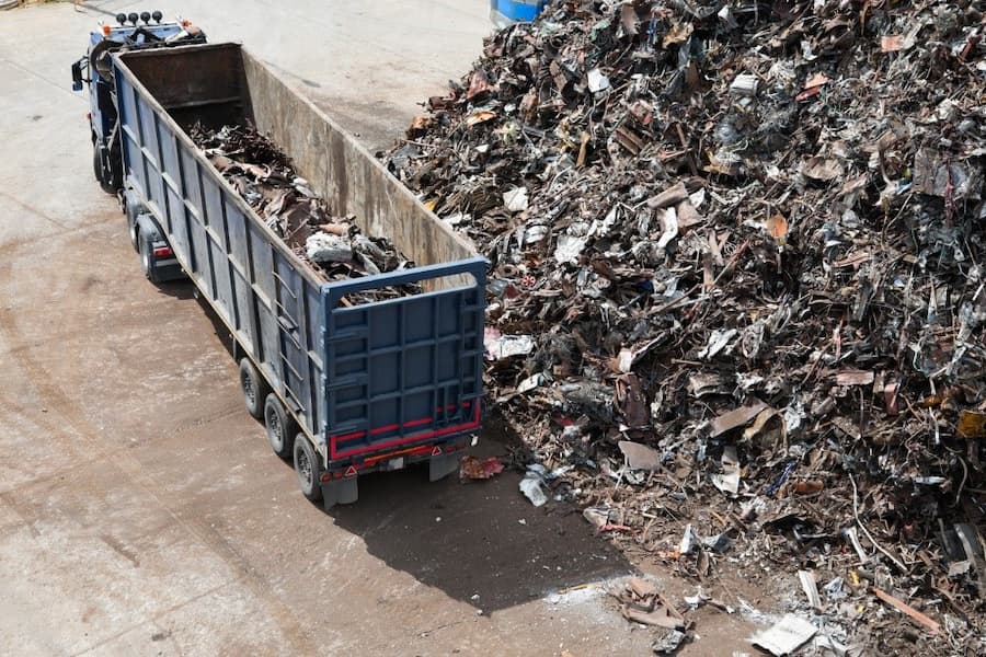 A truck with a large pile of scrap metal