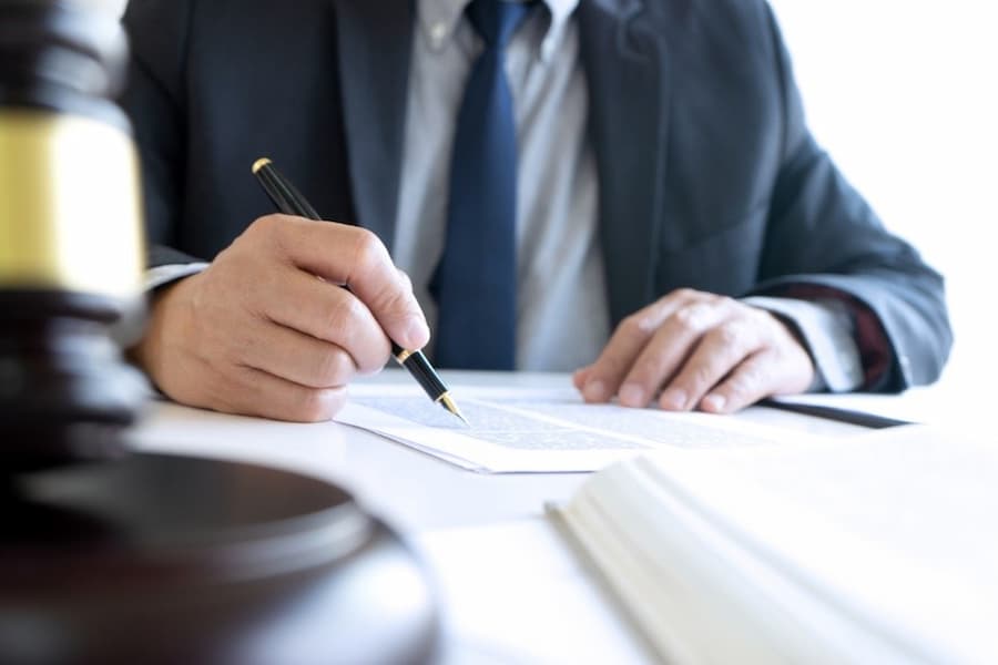 A close-up of a person signing a document