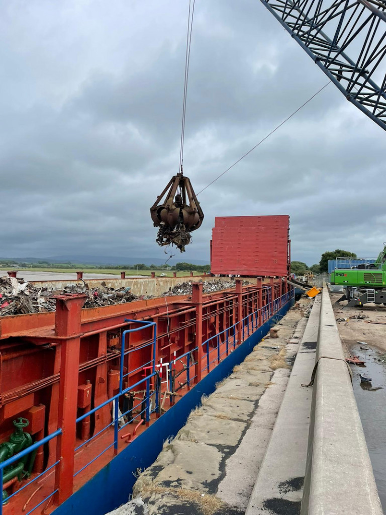 Crane Loading Scrap Metal Onto Boat 