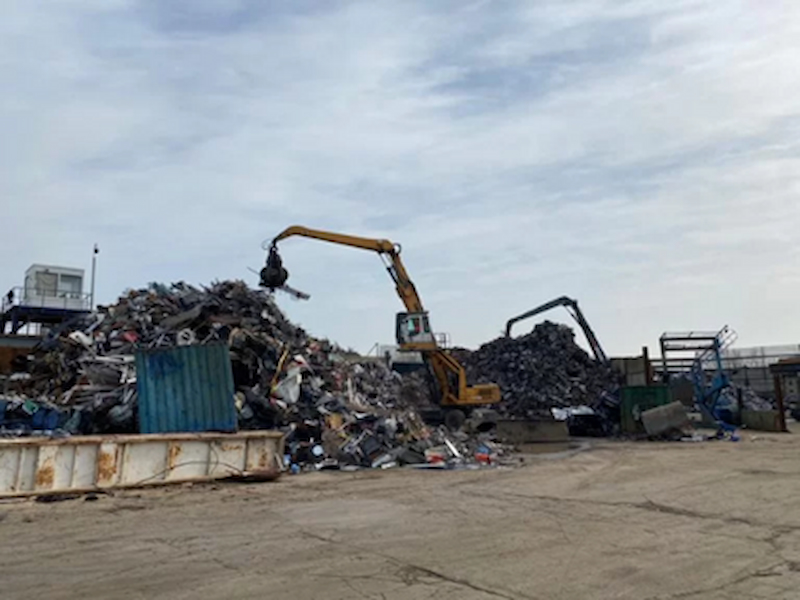 Image of a crane lifting scrap metal at Morecambe Metals