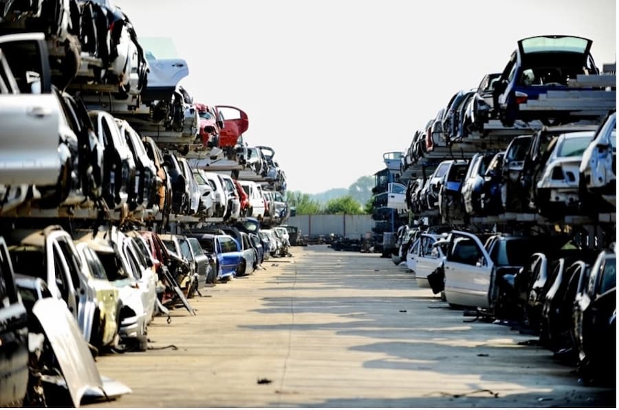 A group of cars stacked on a pallet