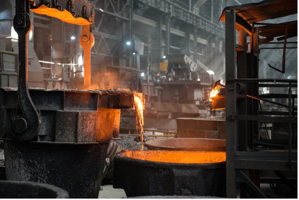 A group of metal containers with liquid pouring into them